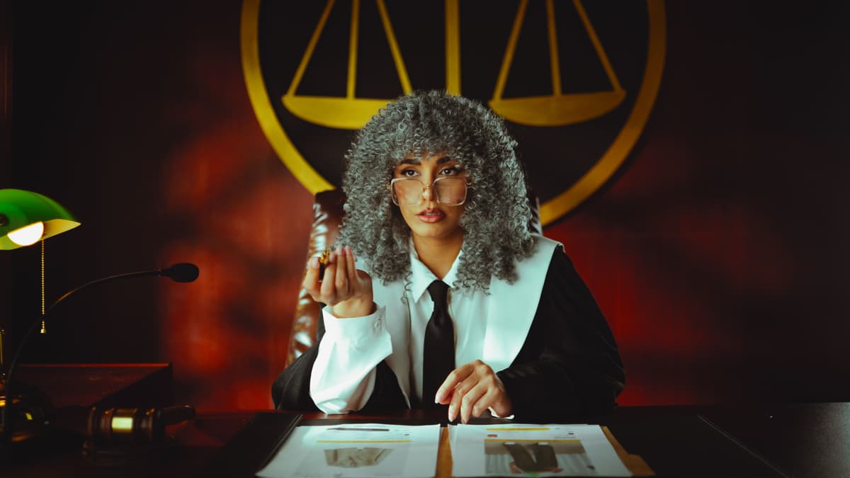 Professional portrait of a male lawyer in a dark suit against a neutral background