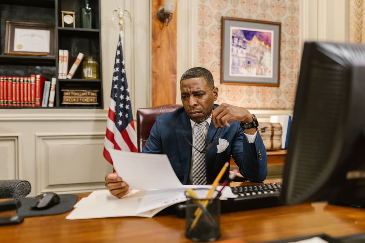 Professional portrait of a male attorney smiling confidently in an office setting